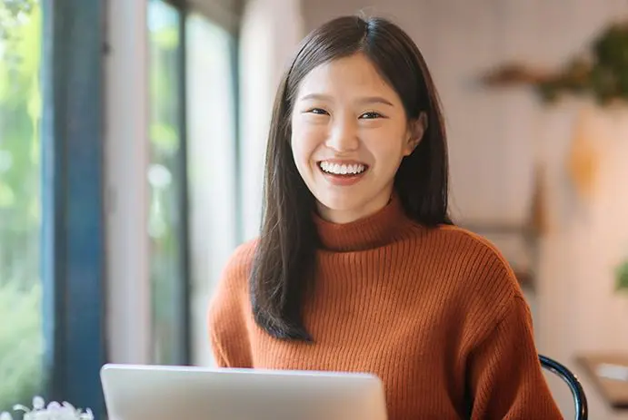 Young Asian woman studying on a laptop