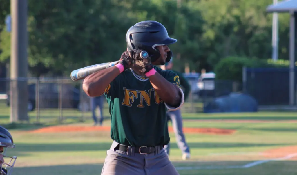 FNU outfielder Jordan Lewis holding a bat