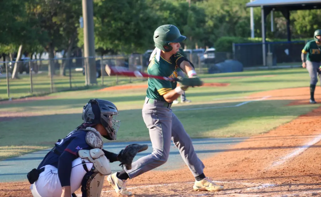 FNU's short stop Jason Altuve swinging a bat versus St. Thomas University.