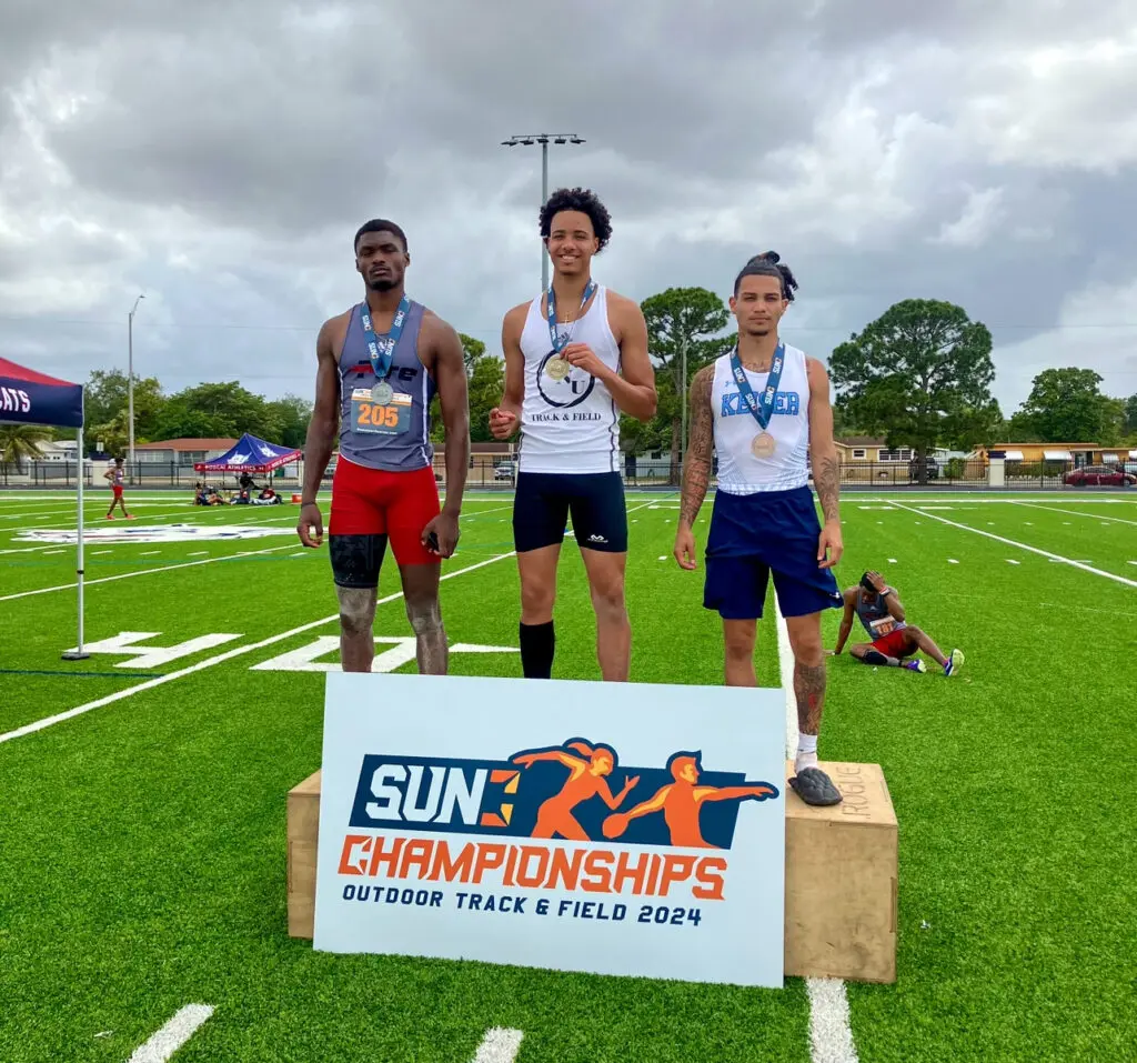 Ivan Rodriguez on the podium after being crowned the Sun Conference champion in the triple jump.