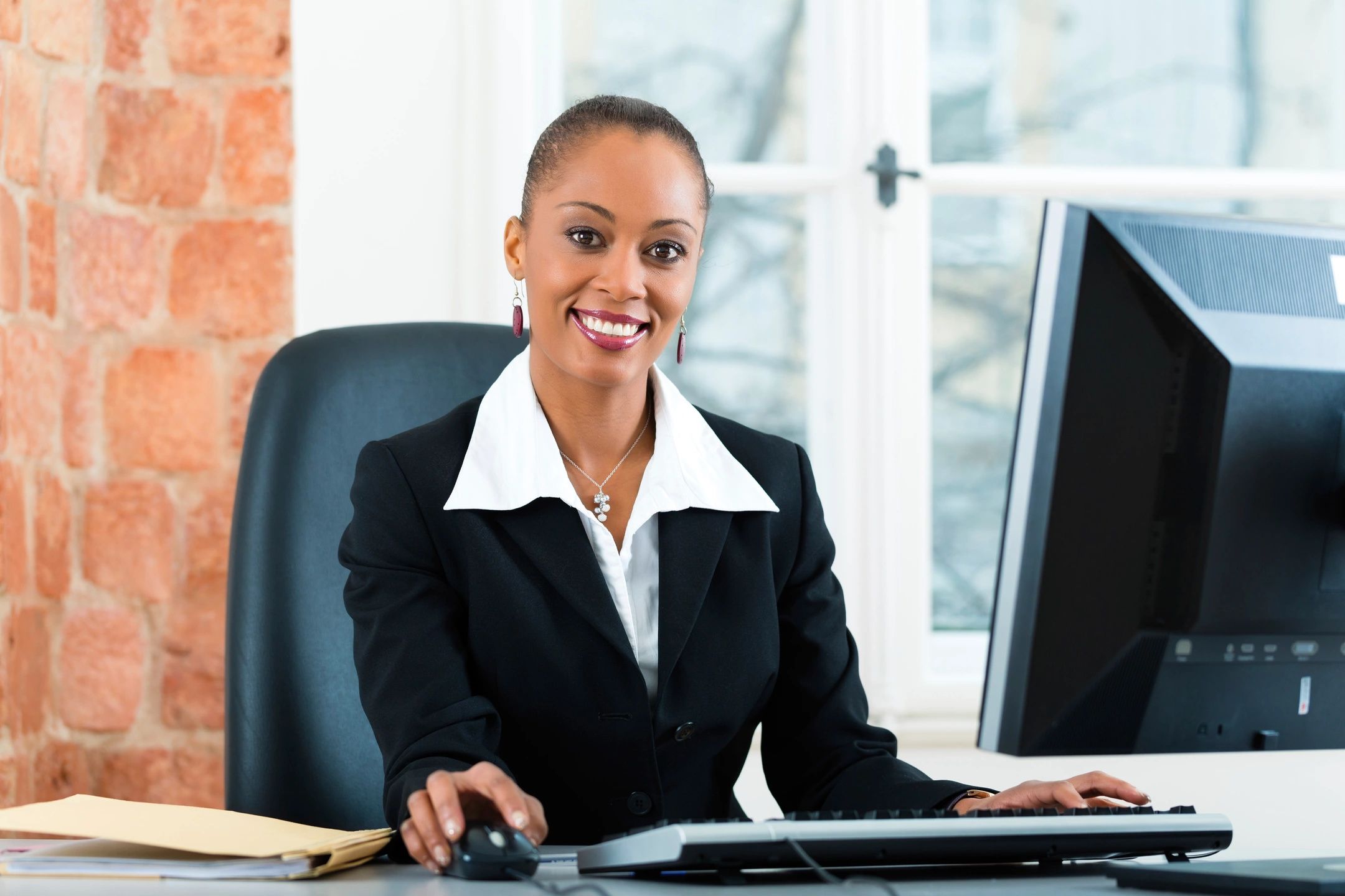 A girl in a law office working on a computer