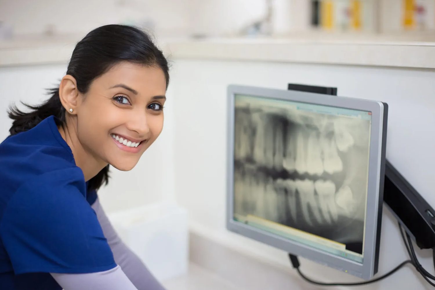 Portrait of a proficient female dental laboratory technician, demonstrating expertise and focus in her work. The image showcases her adept handling of dental materials and instruments, emphasizing the crucial role of women in the field of dental laboratory technology. This photo highlights the professionalism and competence of a female dental lab technician in a collaborative and inclusive work environment.