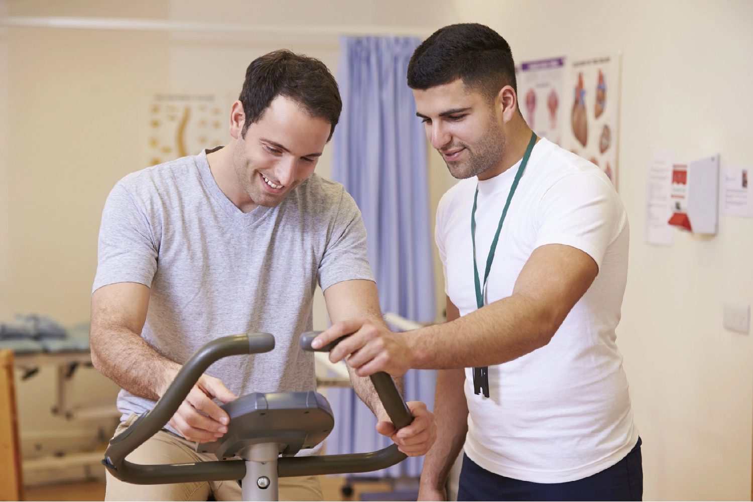 Patient Having Physiotherapy On Exercise Bike In Hospital