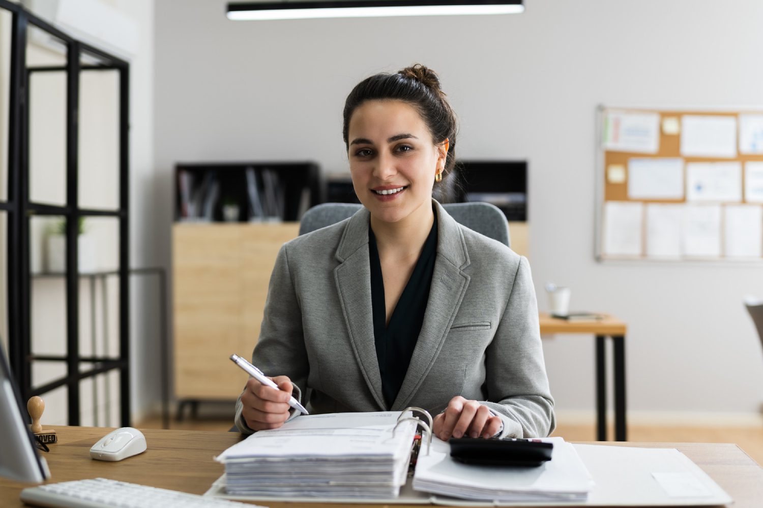 Administrator working on bookkeeping tasks, organizing financial records and managing accounts