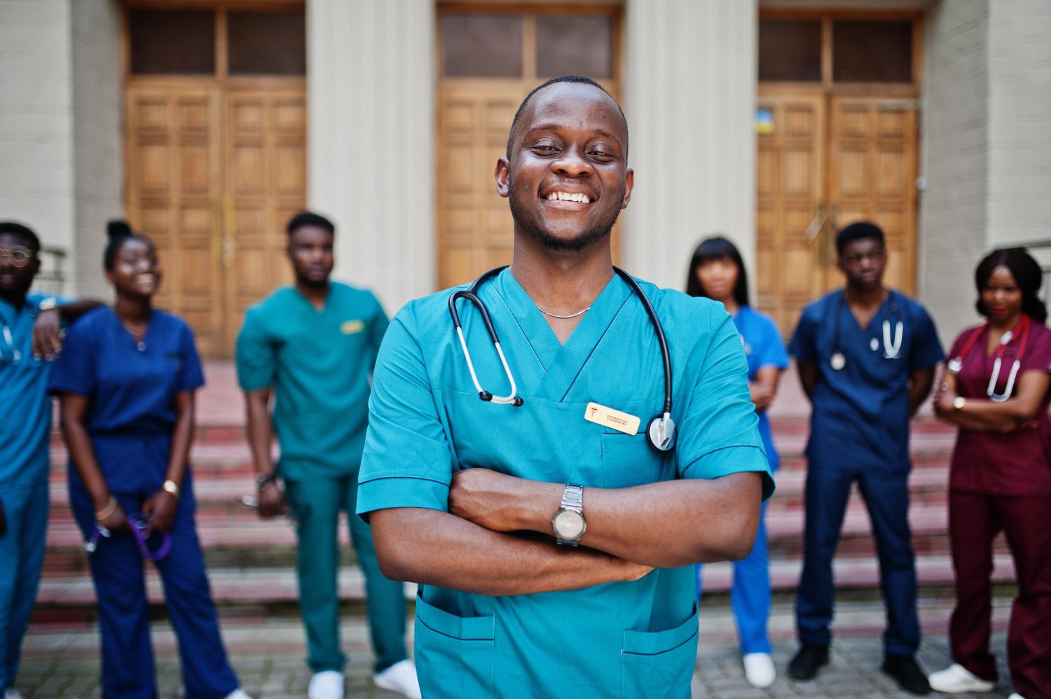 Group of medical students posed outdoor against university door